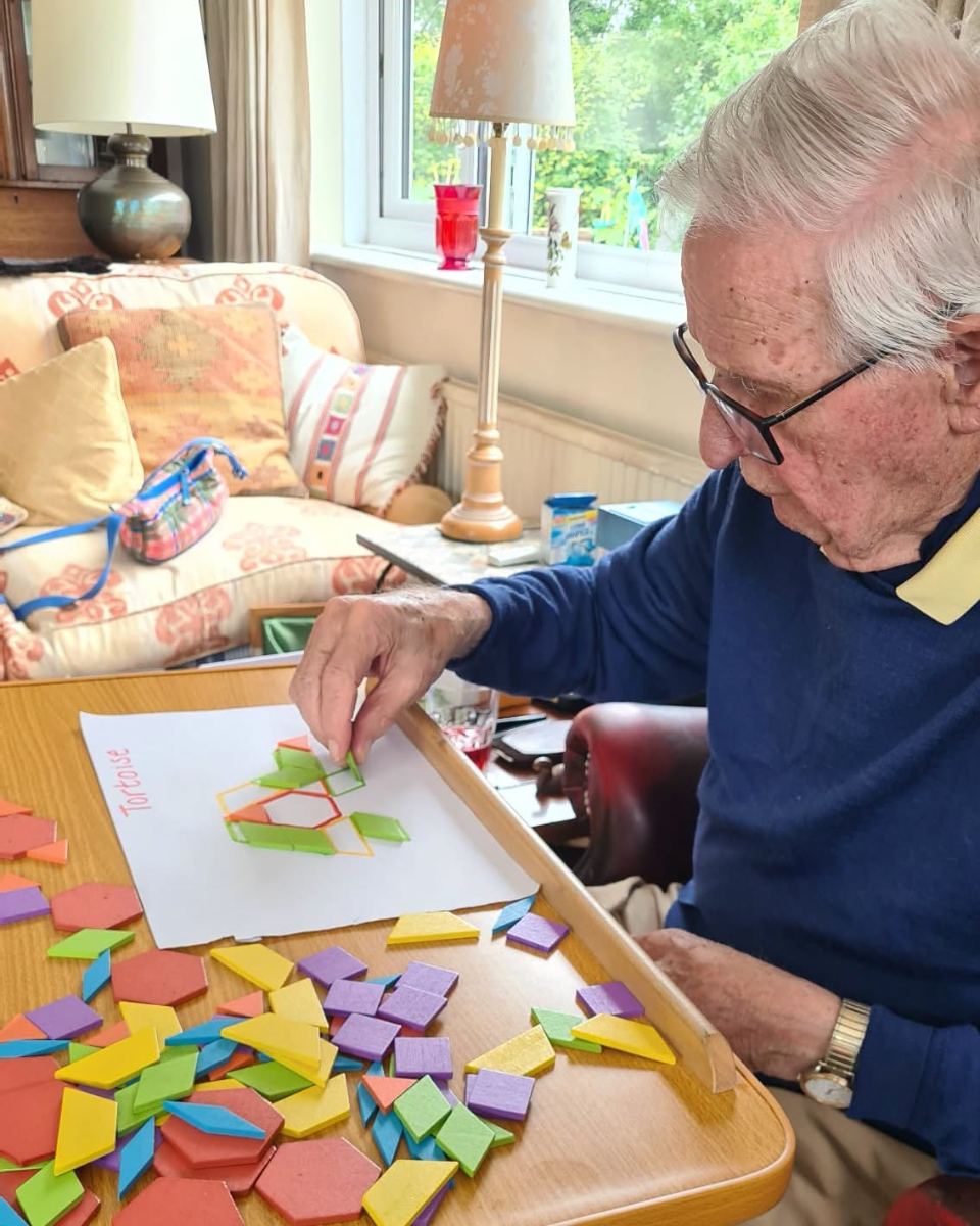 A client working on a shape puzzle at home